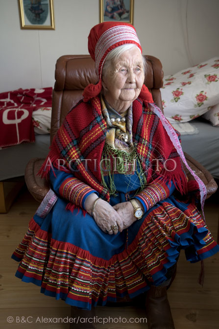Berit Logje, an elderly Sami woman from a reindeer herding family inside her home in Kautokeino. Finnmark, North Norway. (2022)